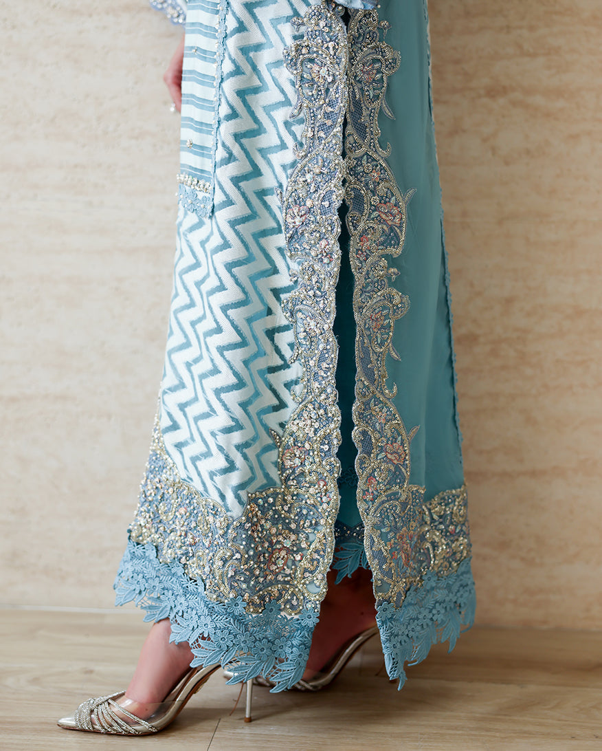 Close-up of embellished hem border on Blue self-patterned brosha suit