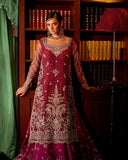 Woman wearing magenta embellished Net bridal gown with sheer sleeves, front view
