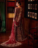 Woman wearing red embellished Net bridal gown with sheer dupatta train, back view