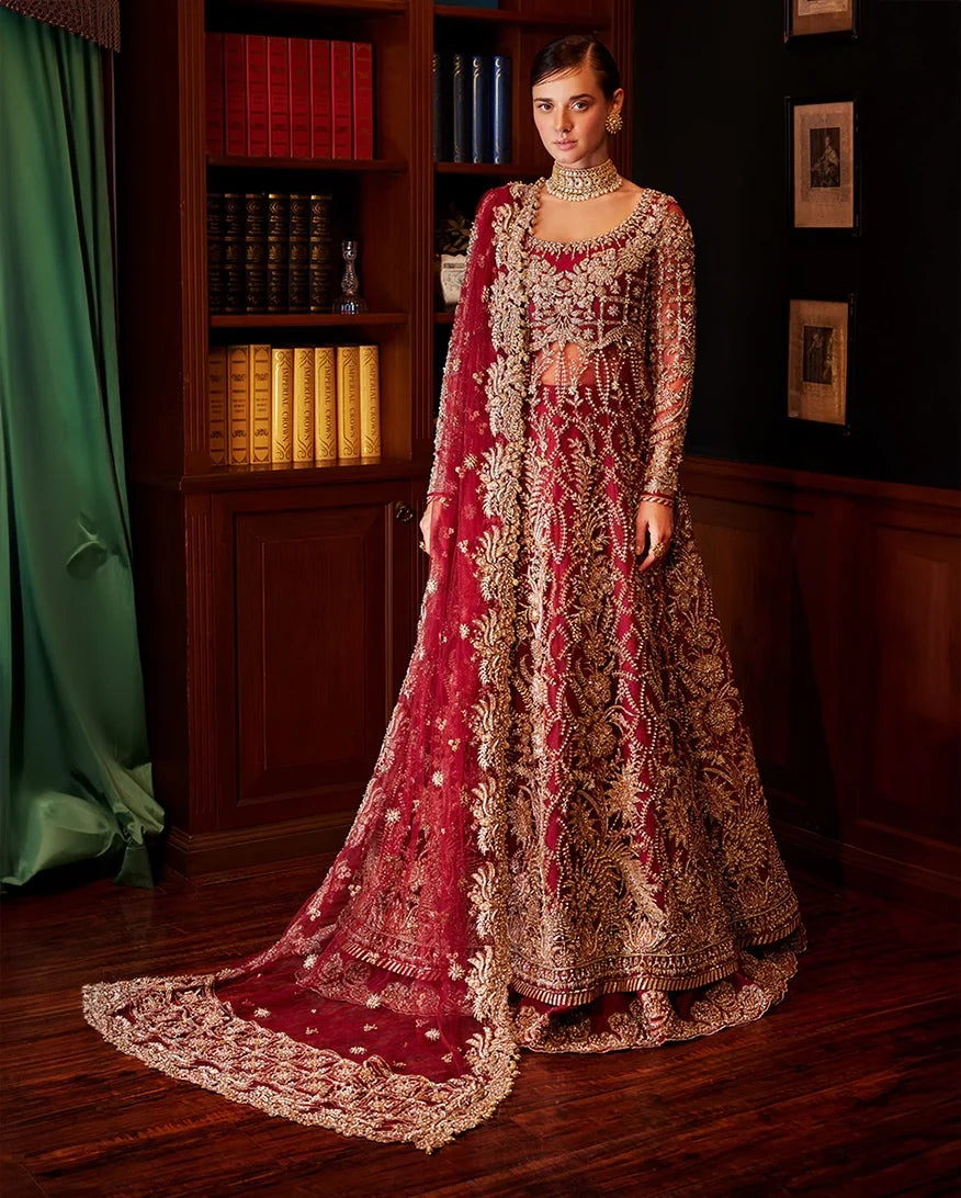 Woman wearing red embellished Net bridal gown with sheer beaded dupatta, front view