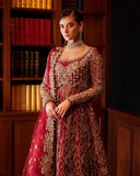 Close-up of woman wearing red Net bridal gown with heavy beadwork on bodice and choker