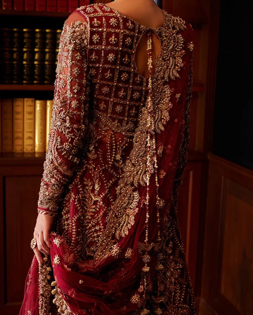 Close-up back view of red embellished Net bridal gown showing beadwork and tassel detailing