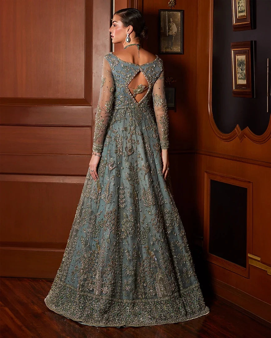Back view of woman wearing teal blue embellished Net bridal gown with cutout back detailing