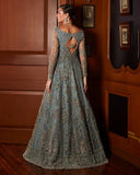 Back view of woman wearing teal blue embellished Net bridal gown with cutout back detailing