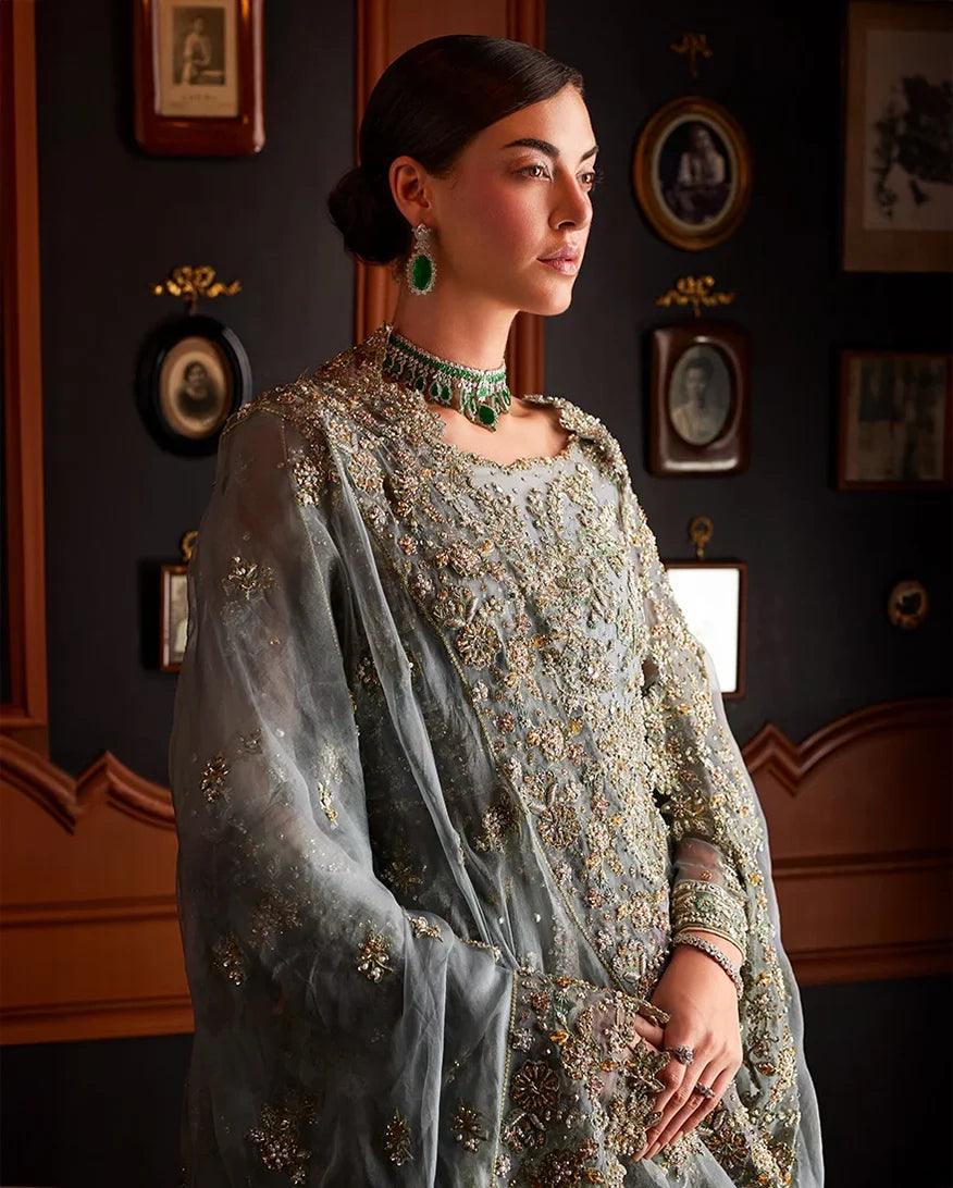 Close-up of woman wearing teal blue embellished Net bridal dupatta with emerald choker