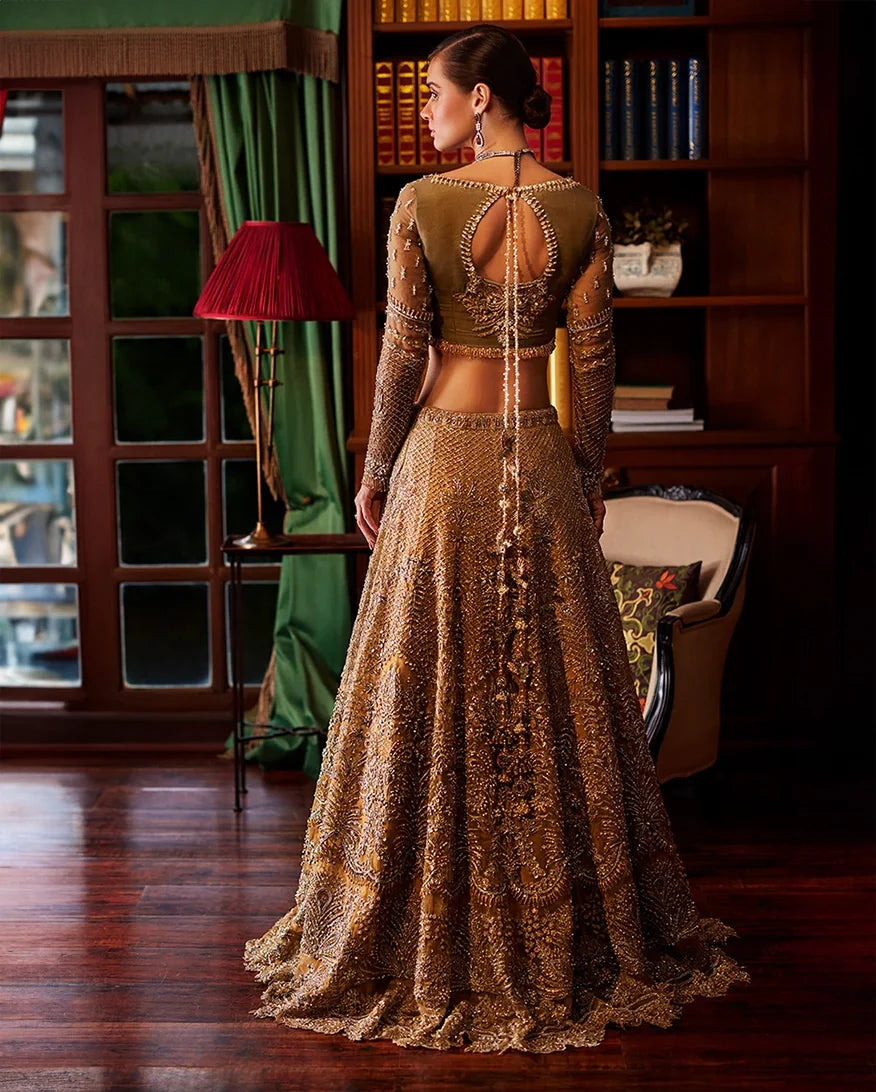 Back view of olive gold bridal lehenga showing keyhole blouse back and beaded tassel trim
