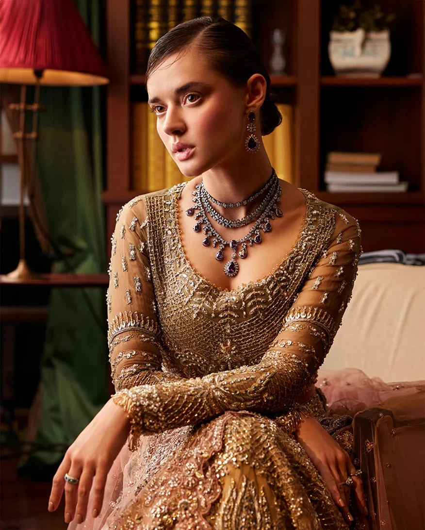 Close-up of embellished bridal bodice with sheer sleeves and layered statement necklace