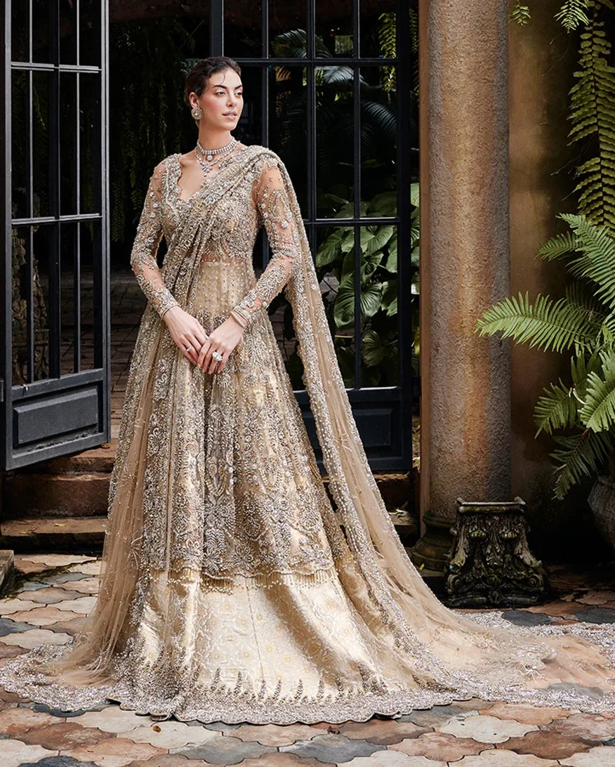 Woman wearing a Beige Net bridal dress with gold embroidery, one of Mushq's bridal dresses