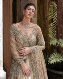 Woman wearing a Beige Net bridal dress with layered jewelry, one of Mushq's pakistani designer bridal dresses