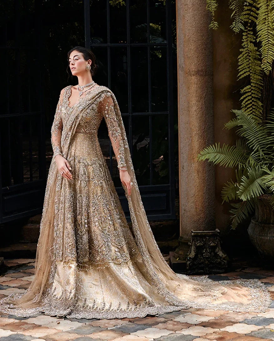 Woman wearing a Beige Net bridal dress with draped dupatta, one of Mushq's pakistani bridal dresses