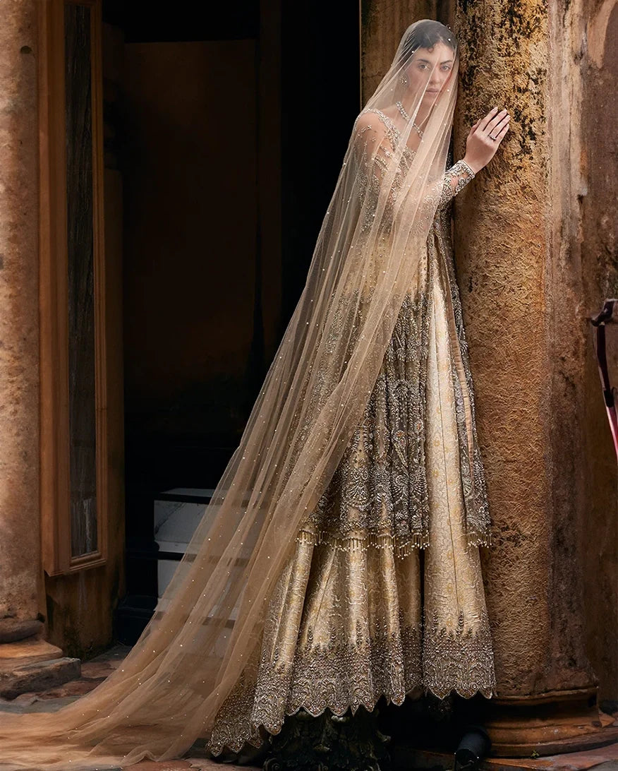 Woman in a Beige Net bridal dress and veil, one of Mushq's pakistani wedding dresse