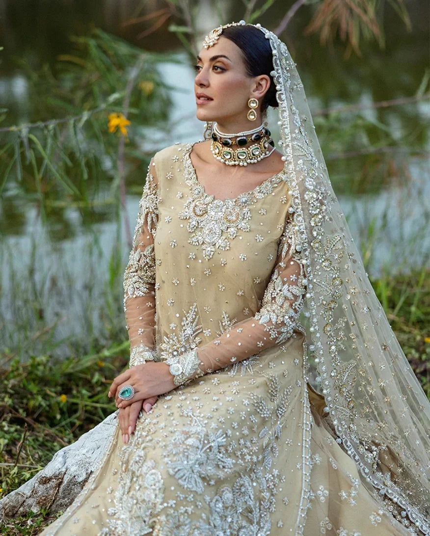 Close-up of woman wearing beige embellished Net bridal bodice with layered choker necklace