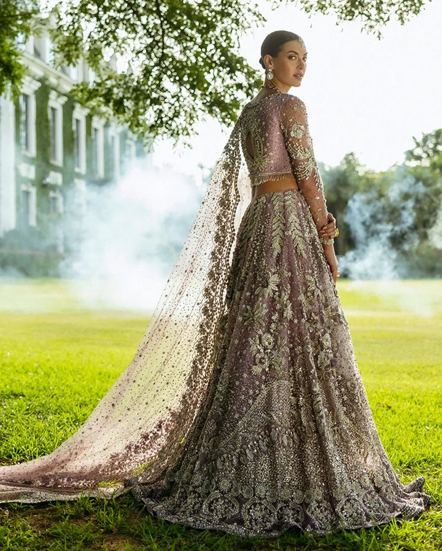 Woman in Purple Net lehenga choli, back view with embroidered dupatta drape, a pakistani designer bridal dresses