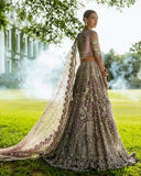 Woman in Purple Net lehenga choli, back view with embroidered dupatta drape, a pakistani designer bridal dresses