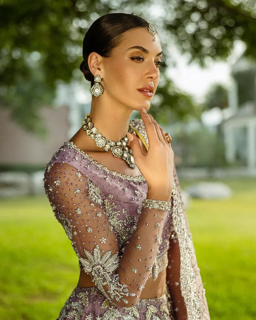 Close-up of Purple Net lehenga choli with pearl embroidery and bridal jewelry, a wedding dress collection