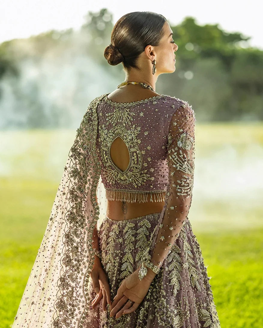 Woman in Purple Net lehenga choli, open-back embroidered blouse detail, a pakistani bridal dresses design