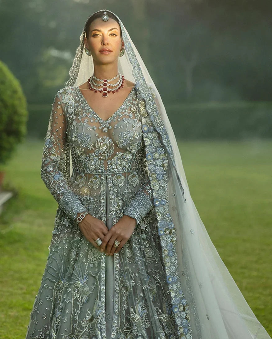 Woman wearing an Ice Blue Net bridal dress with pearl and crystal embroidered bodice, walima bridal dress