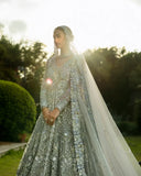 Woman wearing an Ice Blue Net bridal dress with crystal floral embroidery, one of Mushq's pakistani wedding dresses