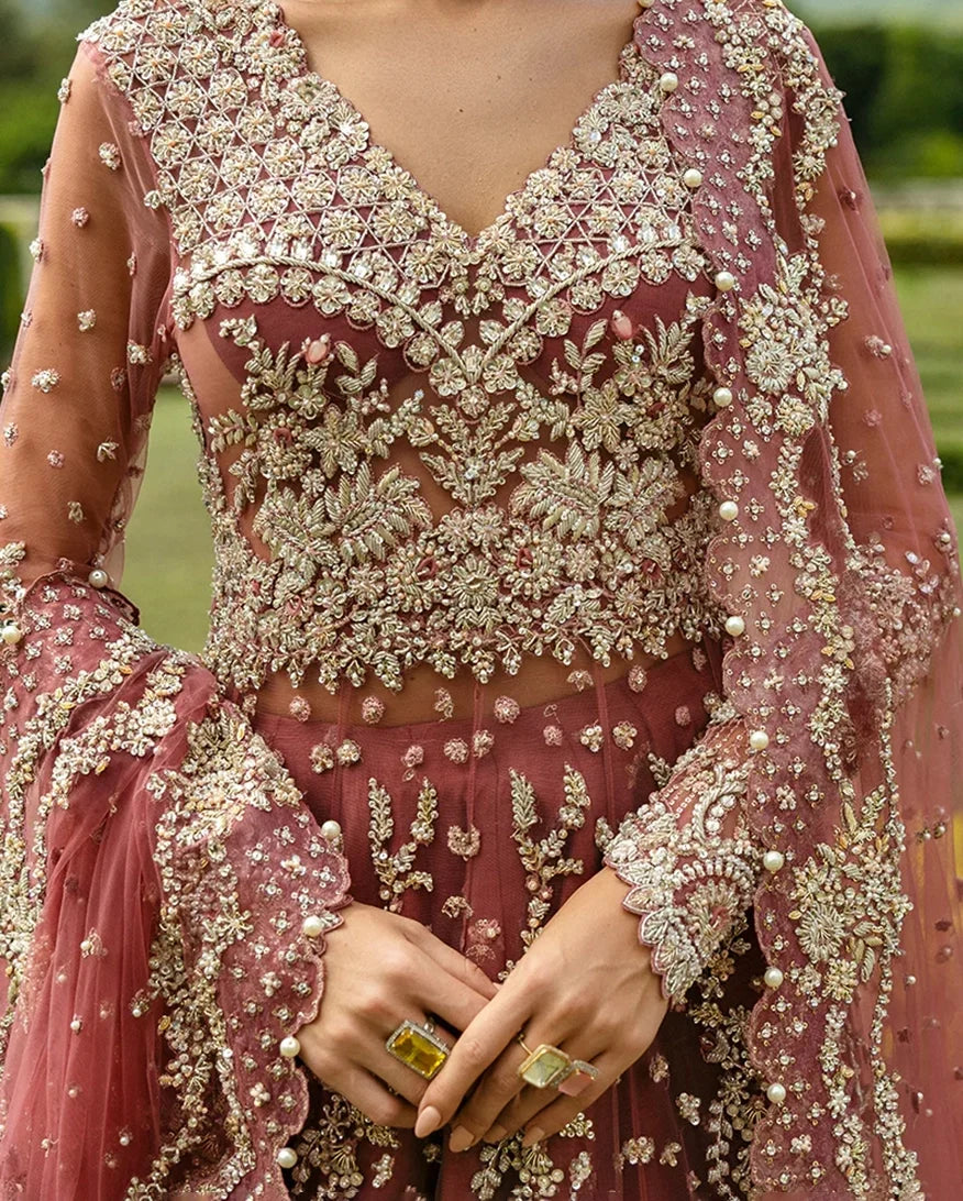 Close-up of a Tea Pink Net bridal dress with floral embroidery, a bridal brand in Pakistan