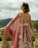 Woman in a Tea Pink Net bridal dress, open-back view, part of Mushq's wedding dress collection