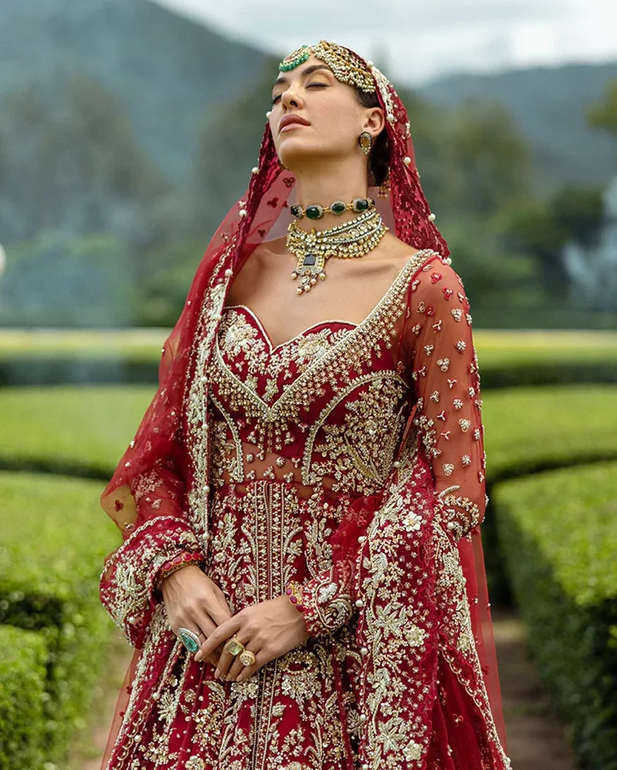 Close-up of woman wearing blood red embellished Net bridal bodice with layered choker