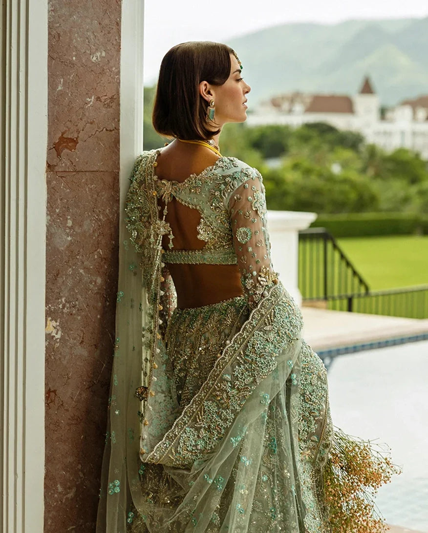 Back view close-up of aqua green embellished Net bridal lehenga with open back detailing