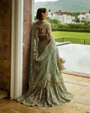 Back view of woman wearing aqua green embellished Net bridal lehenga with sheer dupatta