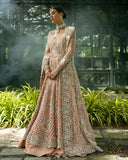 Woman wearing peach embellished Net bridal lehenga with jacket-style bodice