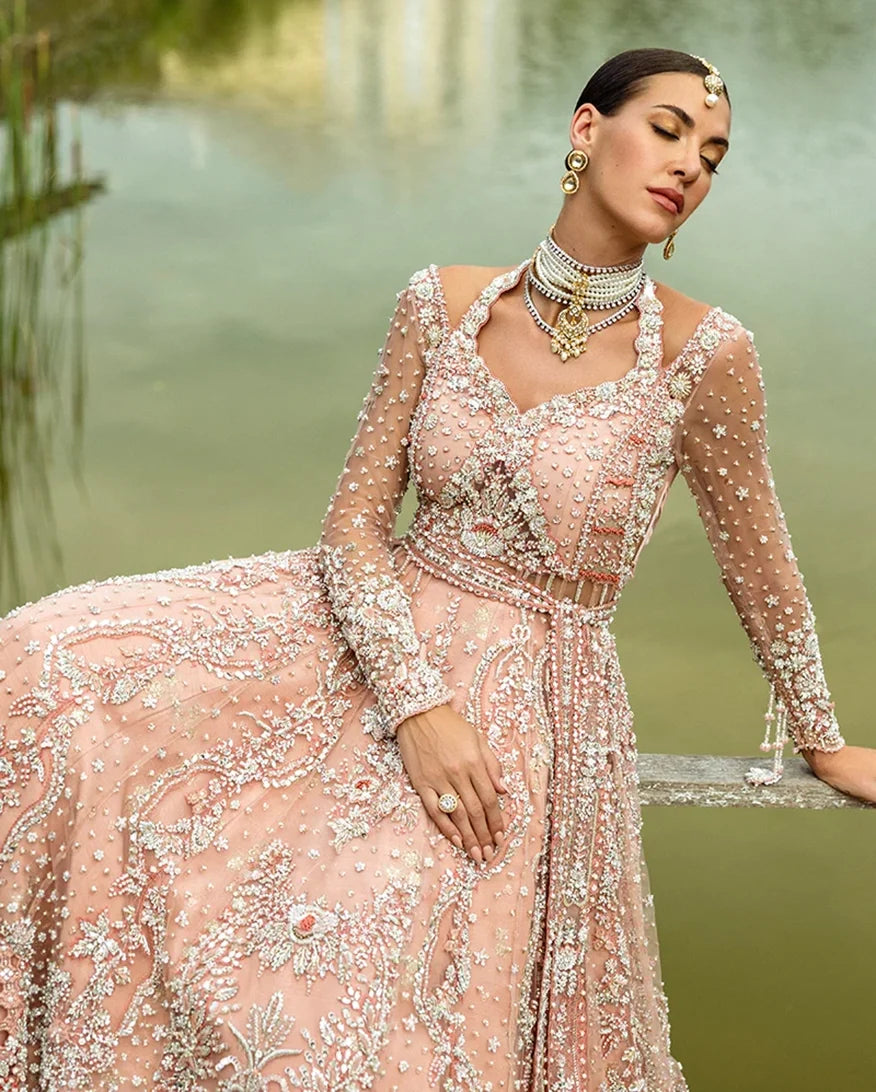 Close-up of woman wearing peach embellished Net bridal bodice with star and pearl detailing