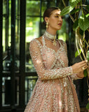Close-up of woman wearing peach embellished Net bridal bodice with pearl embroidery