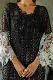Close-up of the embroidered neckline and floral cuffs on a Black Net suit