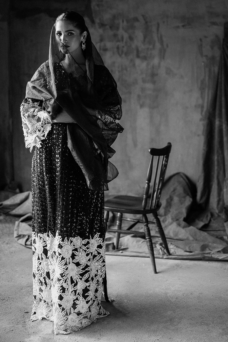 Black-and-white portrait in a Black Net suit with an organza veil draped over the head