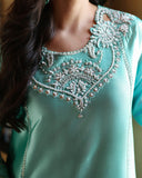 Close-up of neckline embroidery on mint green luxury pret suit, Zarminay collection