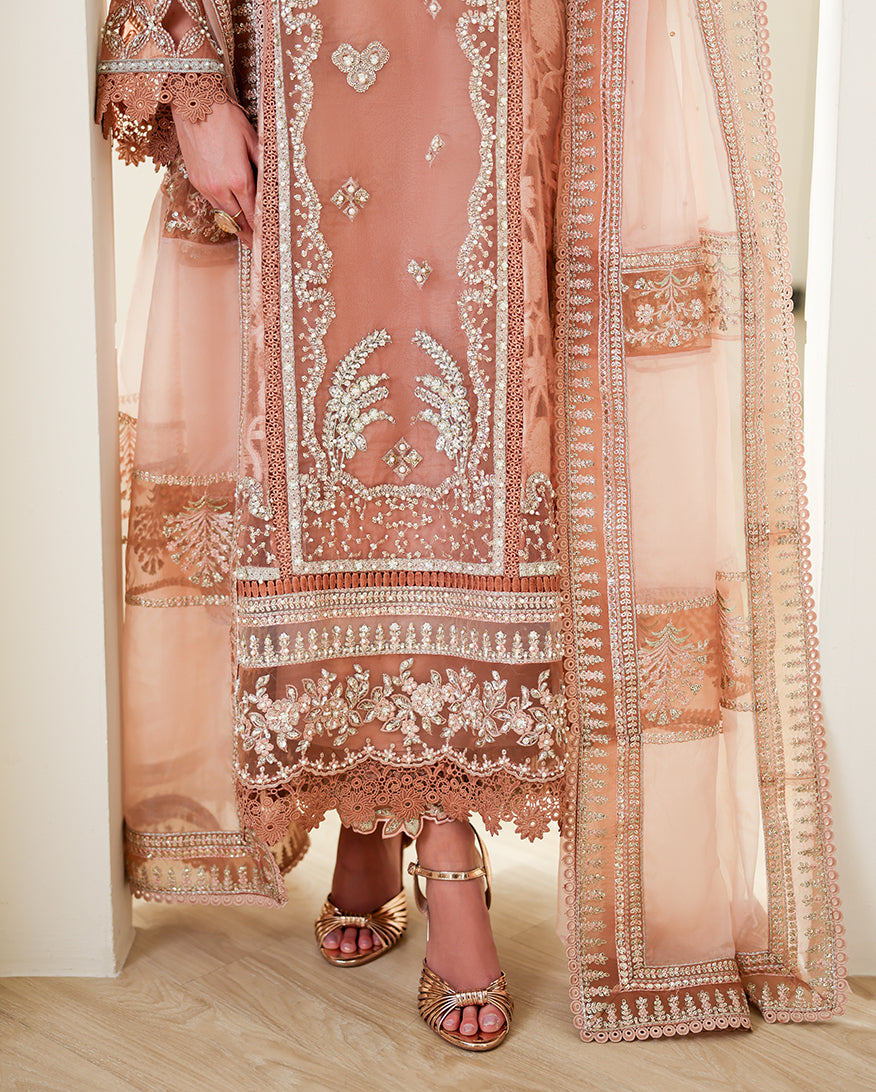 Close-up of embellished front panel and hem detail on Deep Tea Pink brosha suit