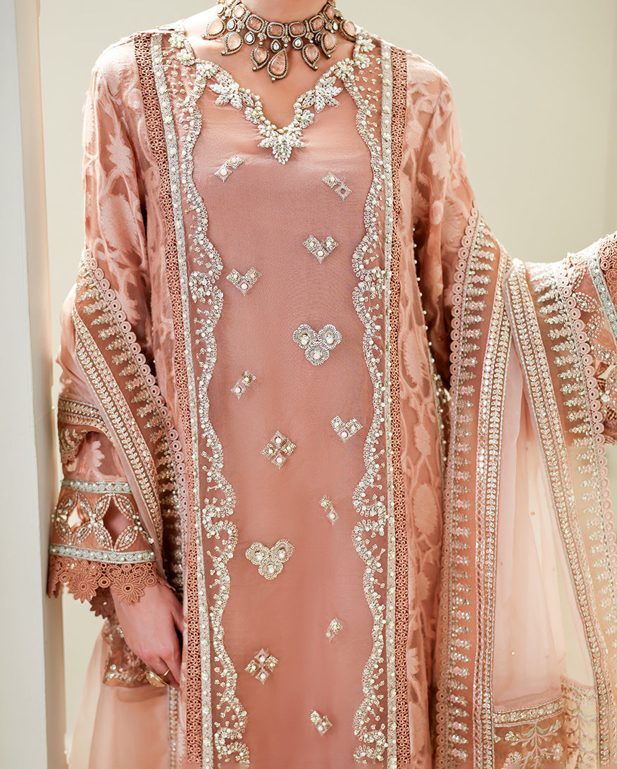 Close-up of embellished V-neckline on Deep Tea Pink brosha suit
