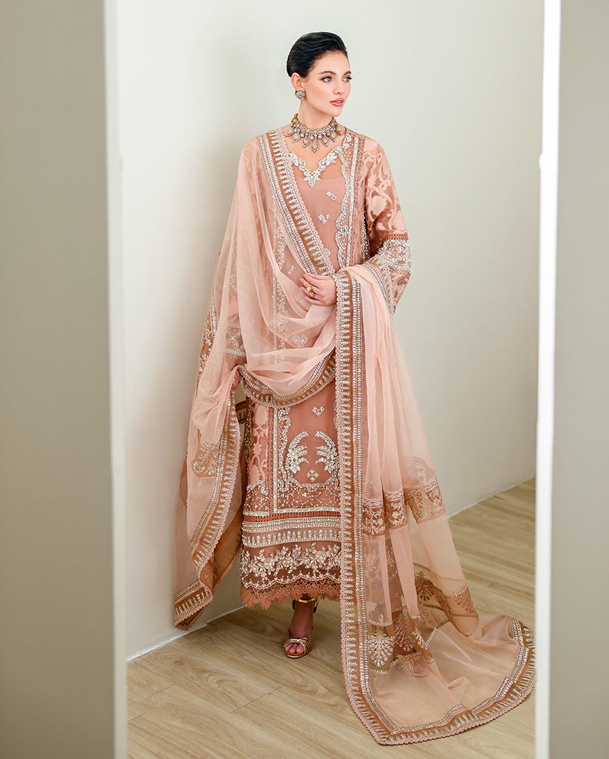 Woman wearing Deep Tea Pink brosha suit with organza dupatta draped over shoulder
