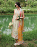 Woman standing by lake wearing lemon yellow unstitched lawn suit with multicolor embroidery, holding flower bouquet, Secret Garden collection