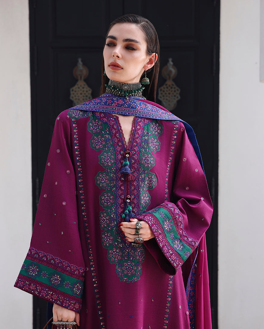 Close-up of hand embellished neckline tassels and crochet lace on magenta raw silk shirt