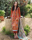 Woman standing near stone well wearing orange unstitched lawn suits with printed dupatta draped aside, Secret Garden collection