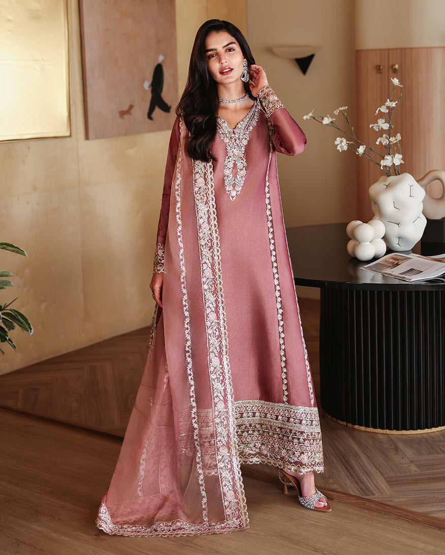 Woman wearing a dusty rose pink luxury pret suit with silver embroidery, Zarminay collection