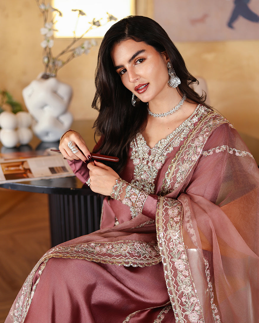 Seated close-up of dusty rose pink luxury pret suit with embroidered neckline, Zarminay collection