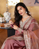 Seated close-up of dusty rose pink luxury pret suit with embroidered neckline, Zarminay collection