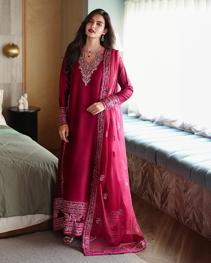 Woman wearing a magenta pink luxury pret suit with silver embroidery, Zarminay collection