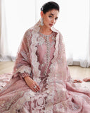 Seated woman in mauve embellished organza suit showing neckline detail