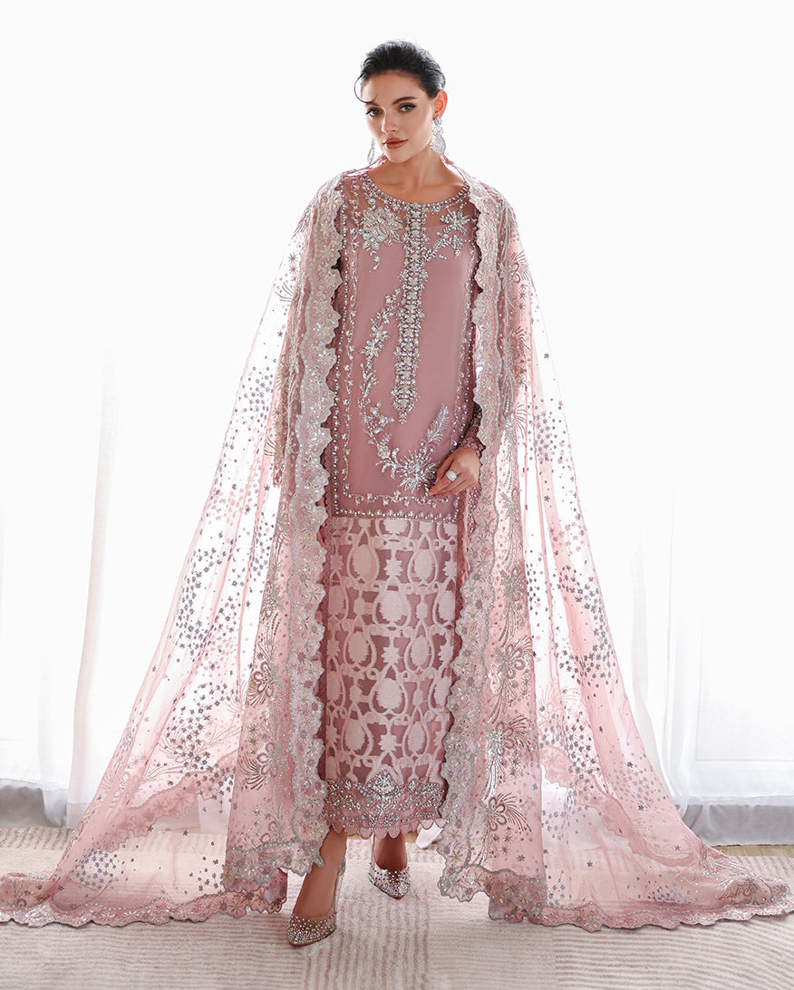 Woman wearing a mauve embellished organza suit with dupatta draped over the shoulders