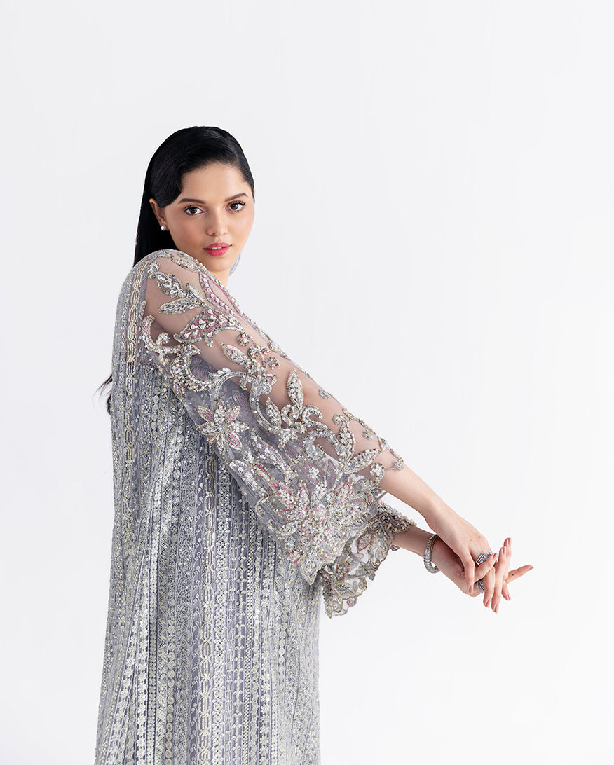 Side view of grey net suit showing beaded fringe skirt and embroidered bodice