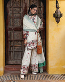 Side view of white raw silk dress showing embroidered silk trouser border and sleeve embroidery