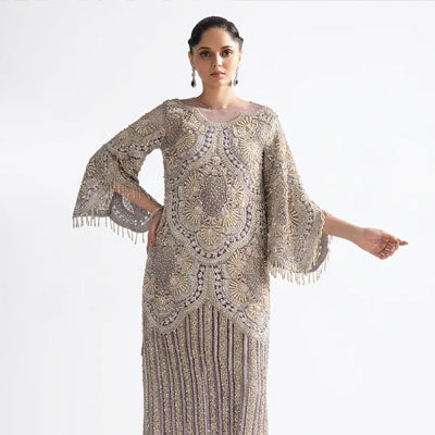 Mushq luxury pret dress in taupe gold with intricate embroidery and embellished bell sleeves for Pakistani weddings and formal festive occasions.