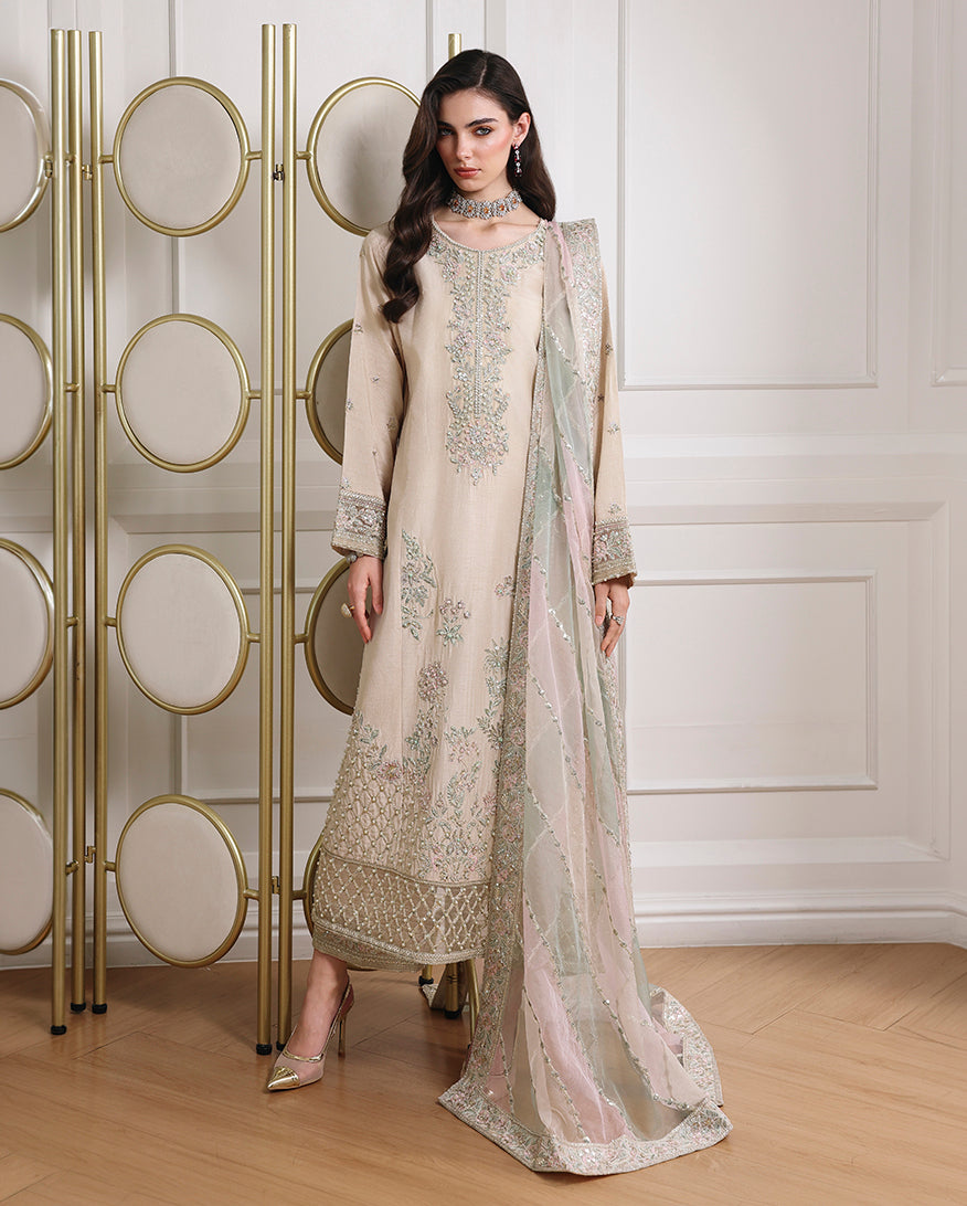 Woman wearing off white Korean raw silk mid-length shirt with straight trouser and organza dupatta