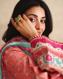 Close-up of embroidered neckline and printed sleeve on peach raw silk shirt